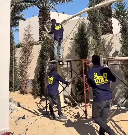 Worker and metal structure during a MAZ exterior shade installation