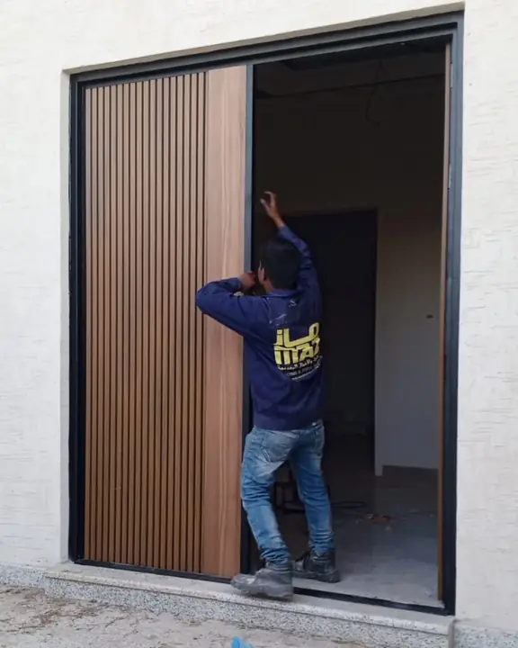 Technician working on an exterior-door detail published by MAZ Business Group